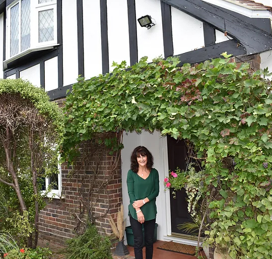 A group of homestay students in a circle looking down and smiling